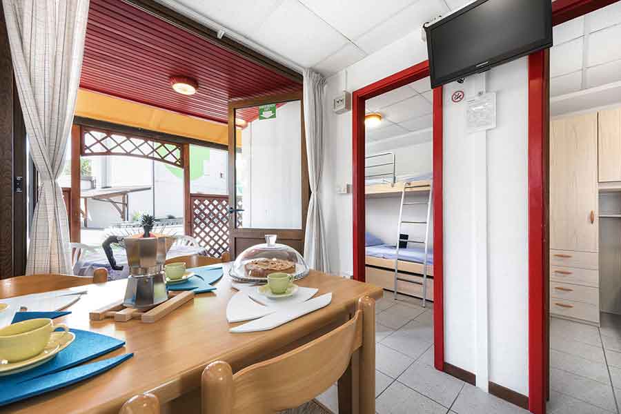 Living room-kitchen with external view of the bungalow