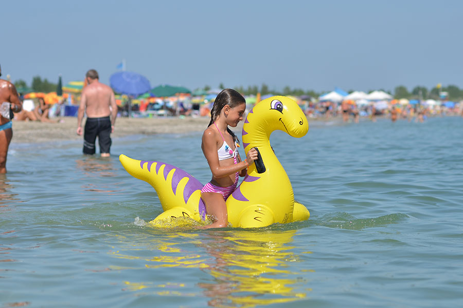 Family playing with sand on the shore