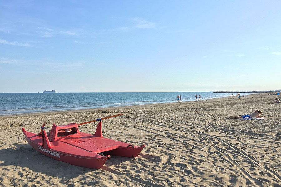 Large free sandy beach with umbrellas